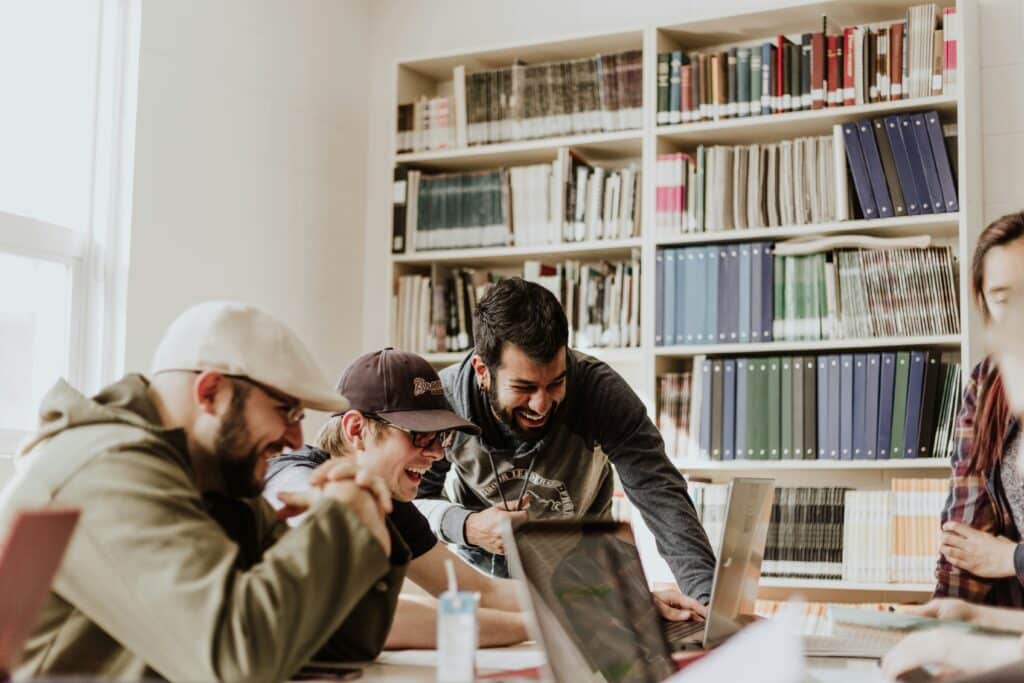 group of men in library smiling and laughing