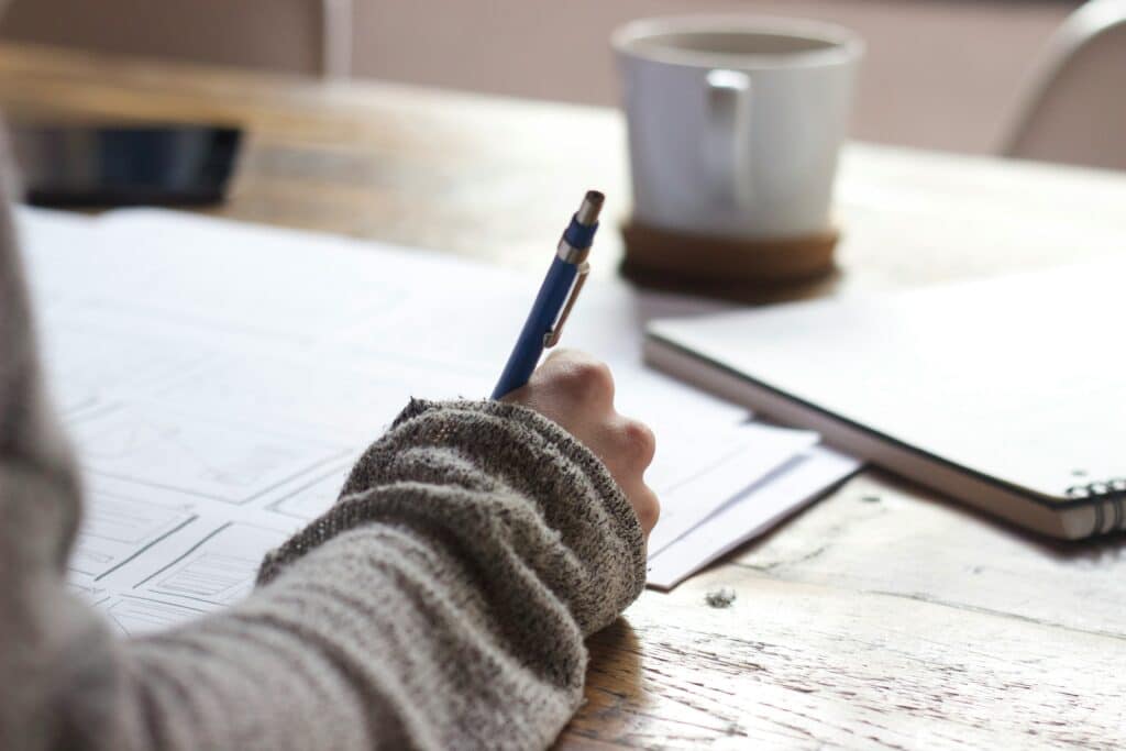 woman writing notes with blurred background
